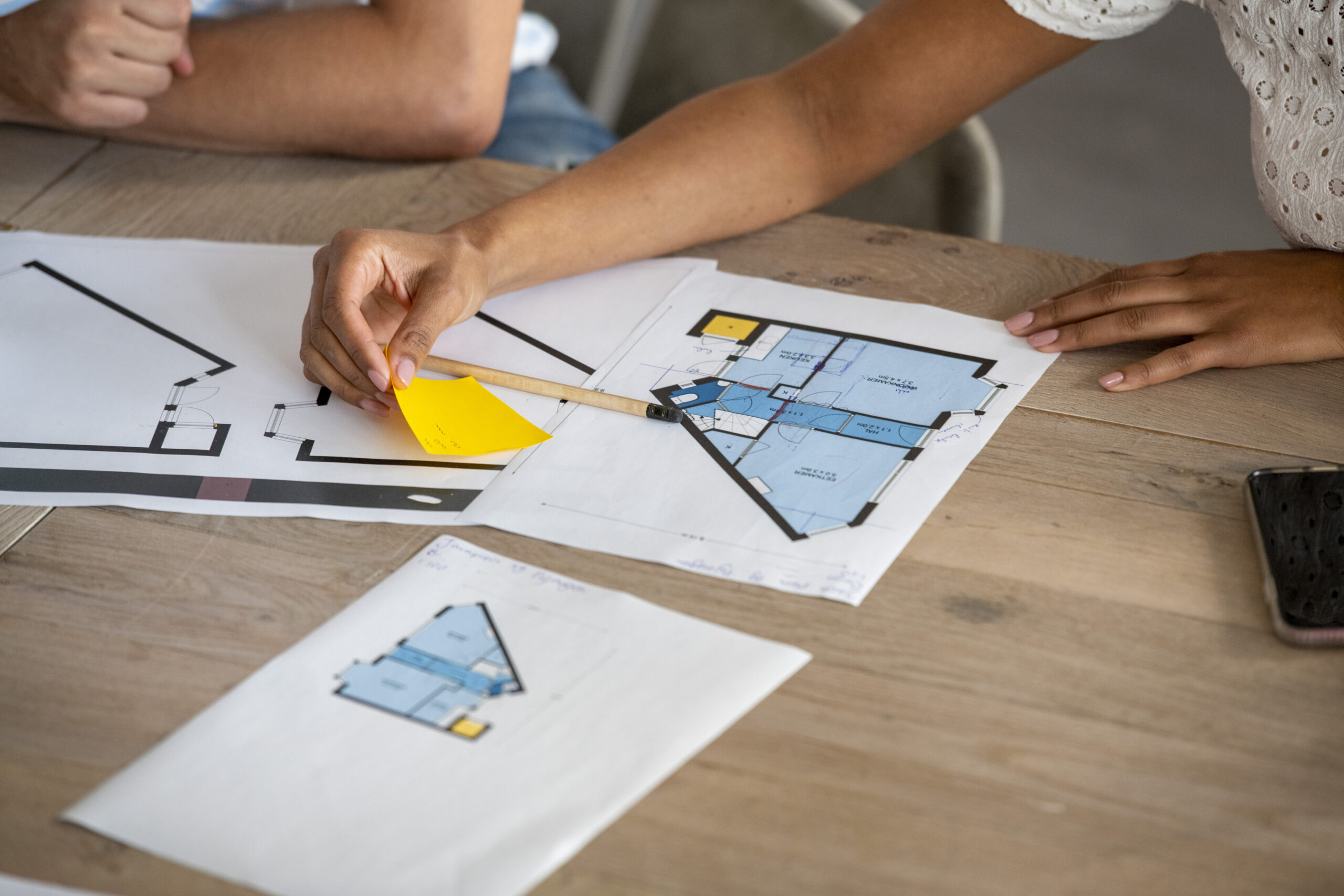 hands-collaborating-on-architectural-floor-plans-o-2025-04-03-03-54-17-utc.jpg